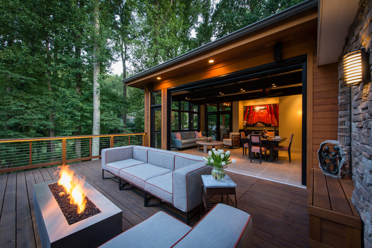 Inspiration for a mid-sized transitional backyard deck in DC Metro with a fire feature and a roof extension.
