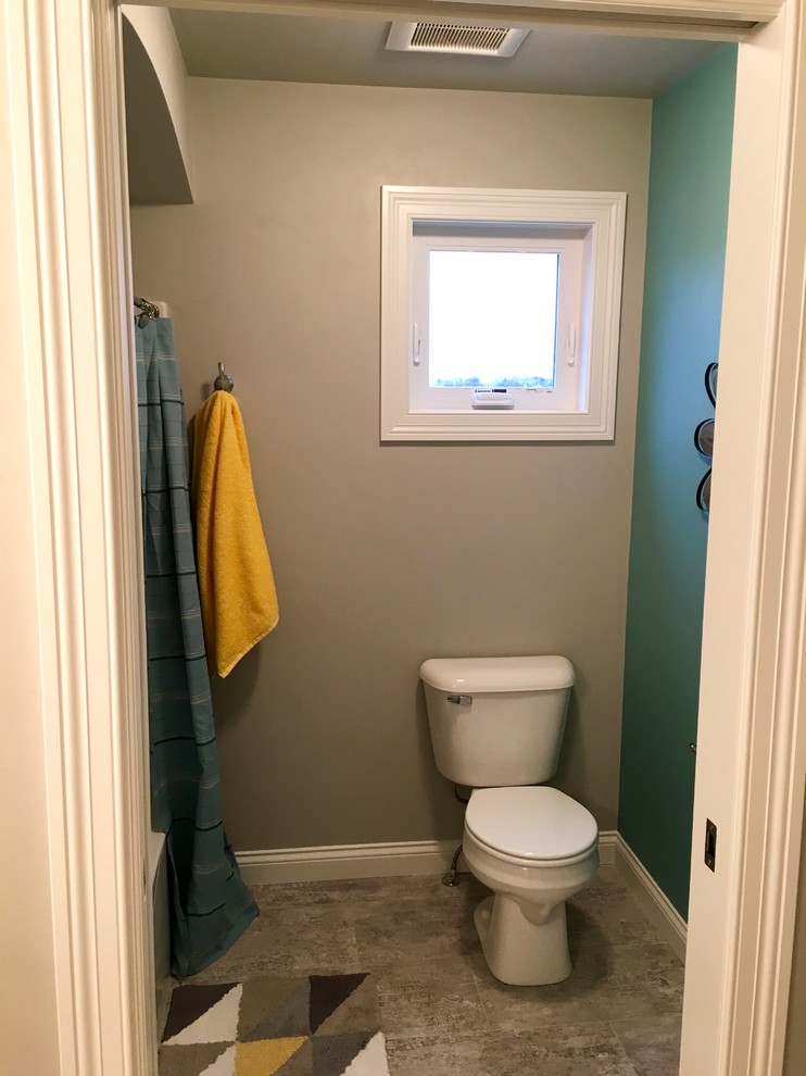 Inspiration for a large arts and crafts kids bathroom in Other with recessed-panel cabinets, white cabinets, a shower/bathtub combo, gray tile, grey walls, a drop-in sink and laminate benchtops.