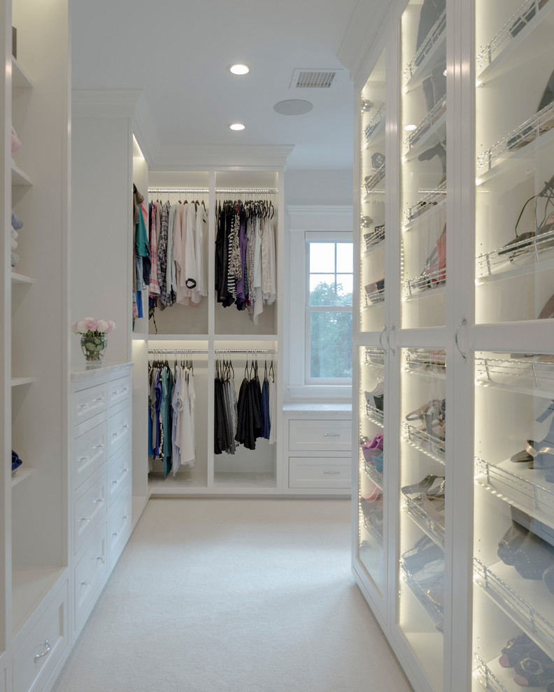Inspiration for a large modern women's walk-in wardrobe in Boston with open cabinets, white cabinets, carpet and beige floor.