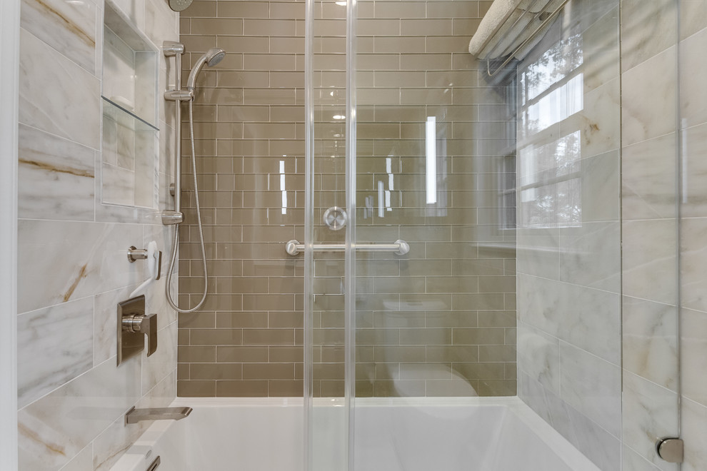 Design ideas for a mid-sized transitional kids bathroom in DC Metro with flat-panel cabinets, white cabinets, an alcove tub, a shower/bathtub combo, a one-piece toilet, multi-coloured tile, beige walls, marble floors, a wall-mount sink, glass benchtops, multi-coloured floor and a sliding shower screen.