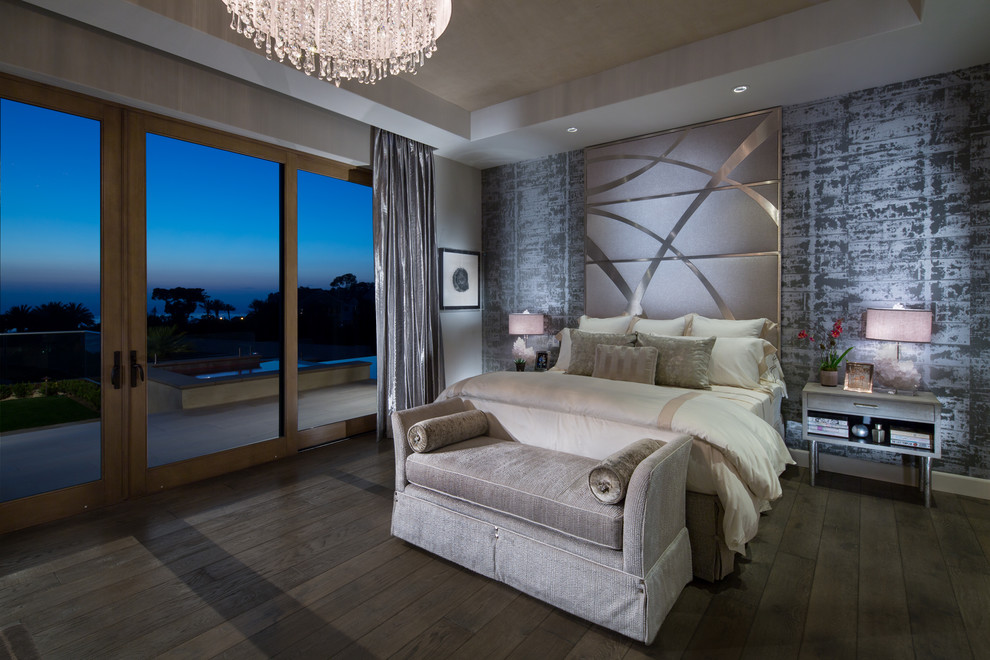Design ideas for a large modern master bedroom in Orange County with multi-coloured walls, a standard fireplace, a stone fireplace surround and light hardwood floors.