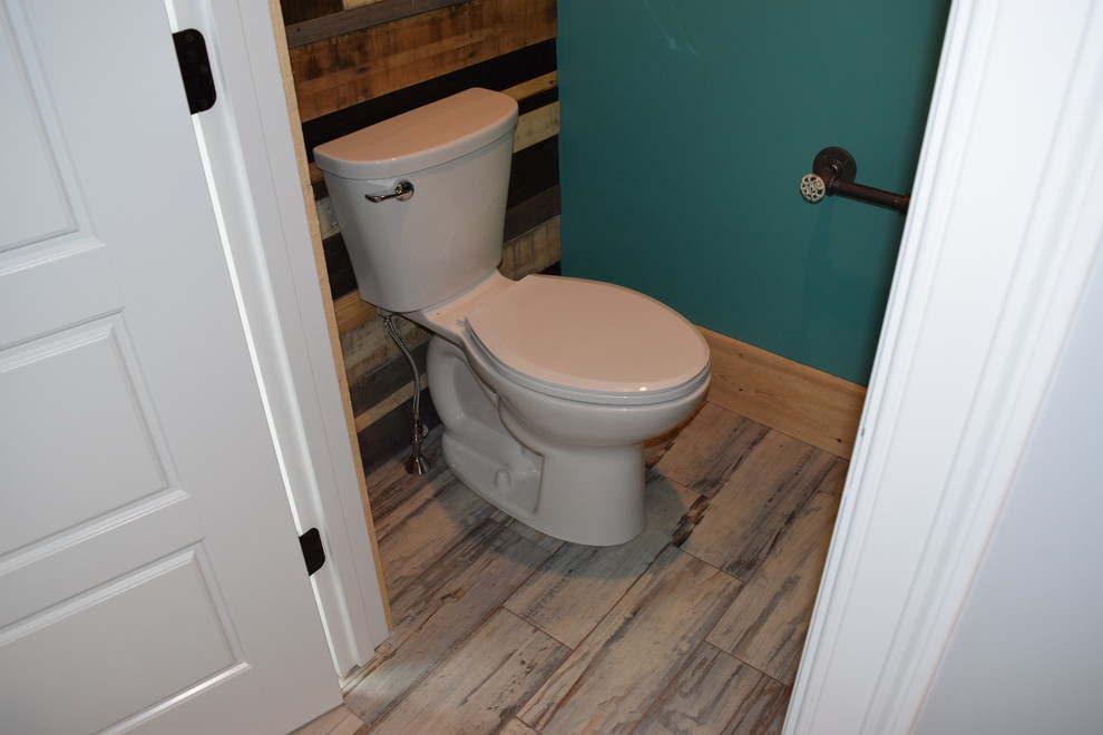 Design ideas for a small traditional powder room in Boston with a two-piece toilet, green walls, light hardwood floors, a vessel sink and beige floor.