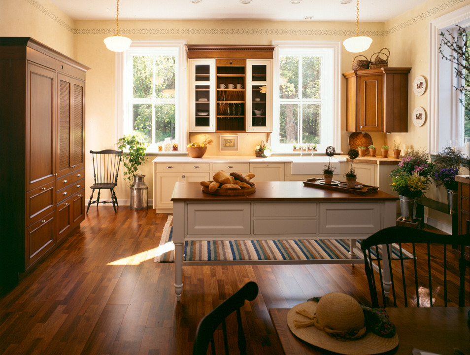 Design ideas for a large transitional u-shaped kitchen in New York with a farmhouse sink, recessed-panel cabinets, panelled appliances, dark hardwood floors and with island.