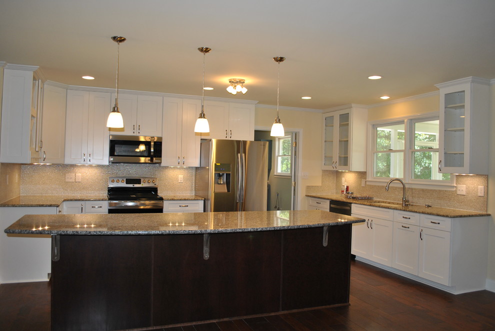 Inspiration for a large transitional single-wall dark wood floor and brown floor eat-in kitchen remodel with an undermount sink, shaker cabinets, white cabinets, granite countertops, beige backsplash, stainless steel appliances and an island