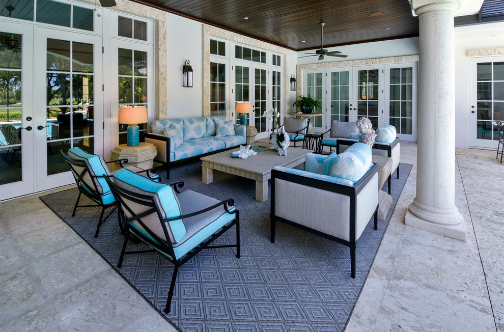 Inspiration for an expansive transitional backyard patio in Miami with an outdoor kitchen, tile and a roof extension.