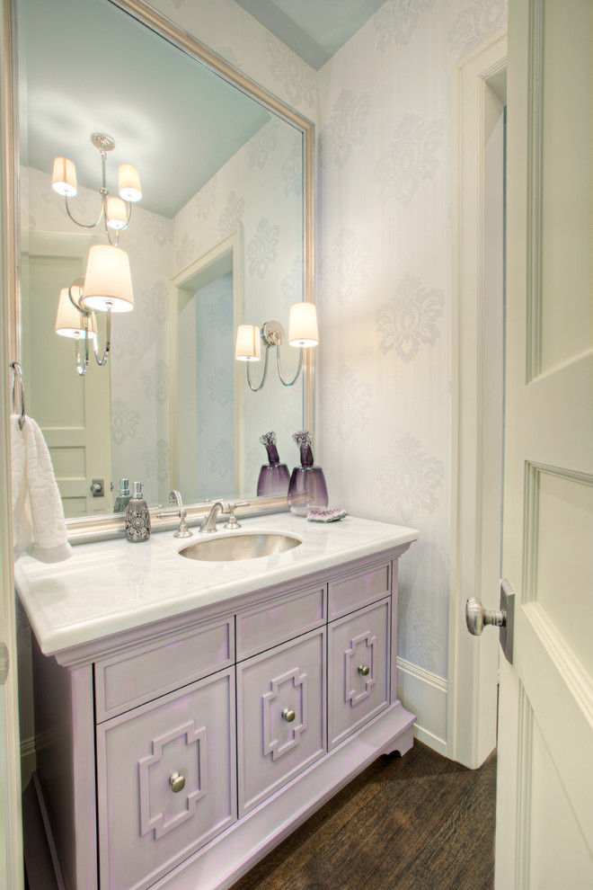 Photo of a transitional powder room in Calgary with an undermount sink and recessed-panel cabinets.