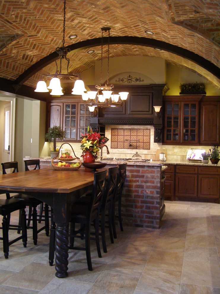 This is an example of a mid-sized country single-wall eat-in kitchen in Houston with glass-front cabinets, dark wood cabinets, beige splashback, stone tile splashback, ceramic floors, with island, beige floor and beige benchtop.