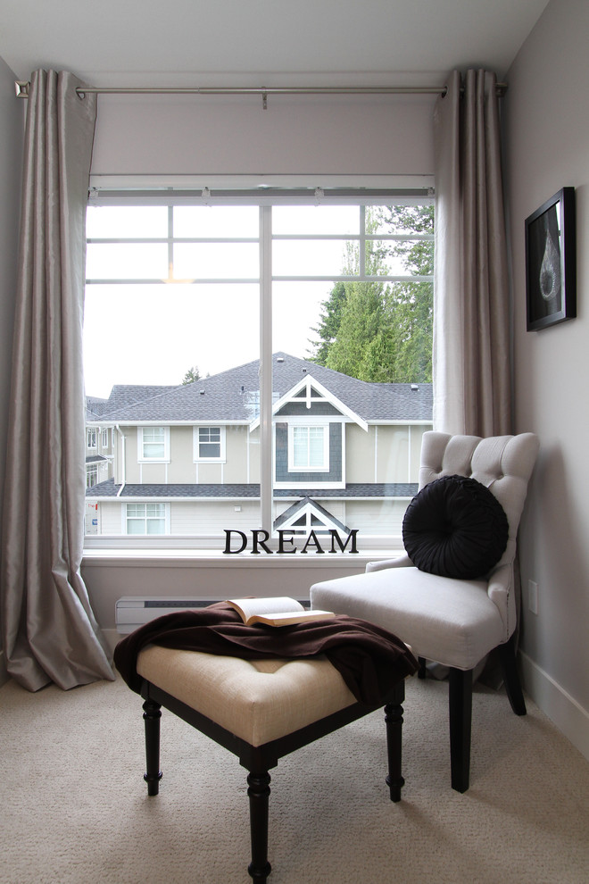 Photo of a large transitional master bedroom in Vancouver with grey walls and carpet.