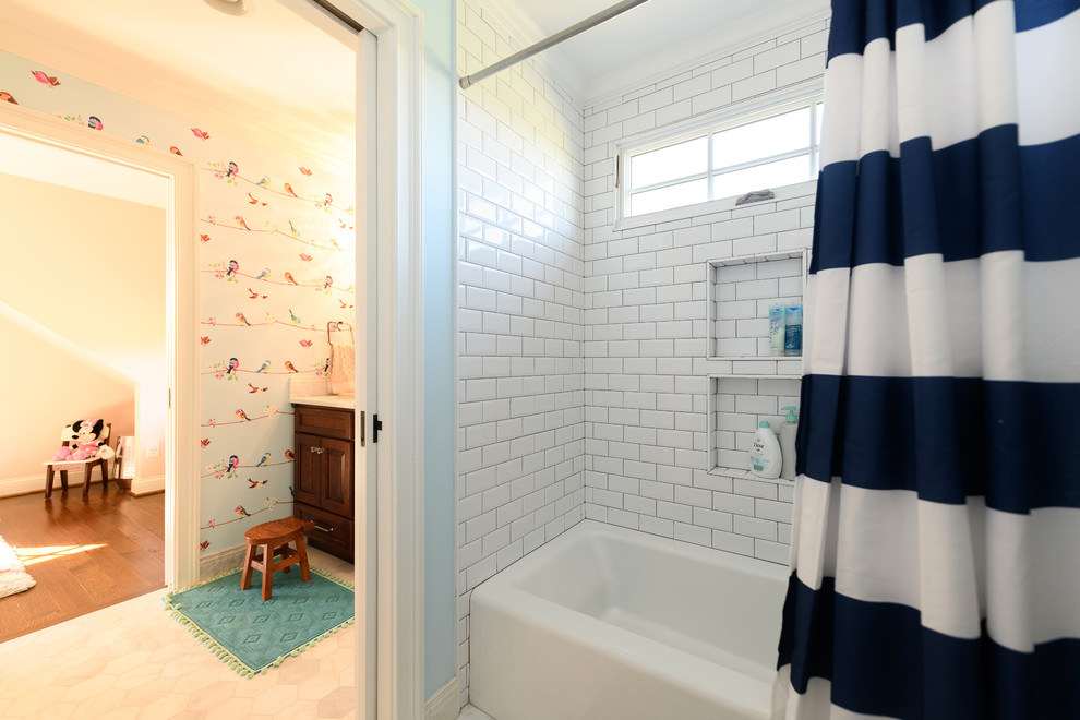 Large transitional 3/4 white tile and subway tile marble floor and white floor alcove bathtub photo with raised-panel cabinets, dark wood cabinets, a two-piece toilet, gray walls, an undermount sink, quartzite countertops and white countertops