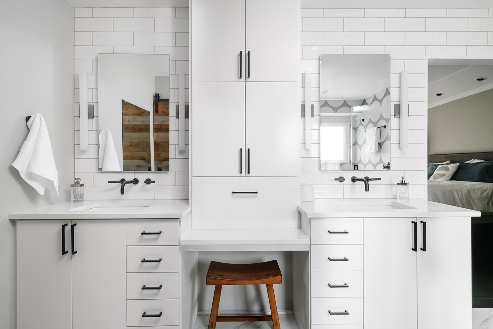 Inspiration for a transitional bathroom in Austin with flat-panel cabinets, white cabinets, white tile, white walls, an undermount sink and white benchtops.