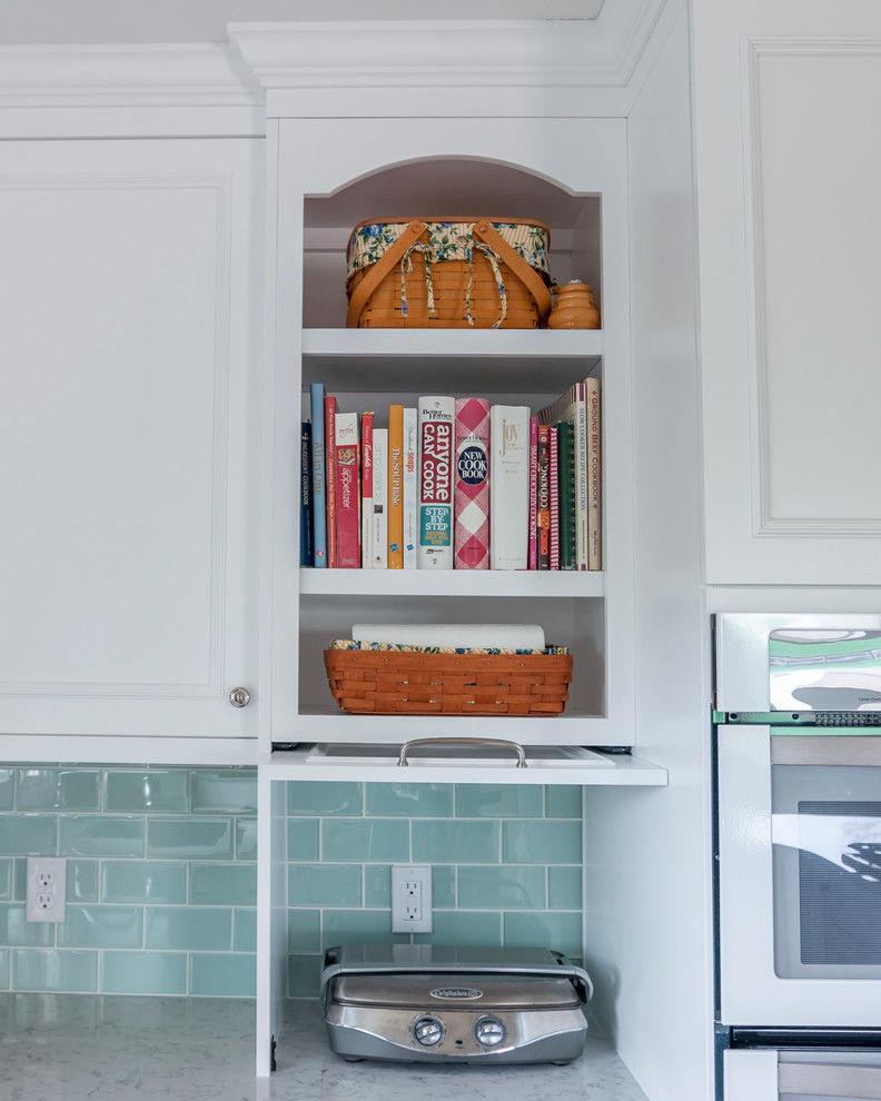 Example of a mid-sized transitional medium tone wood floor eat-in kitchen design in Denver with a single-bowl sink, flat-panel cabinets, yellow cabinets, quartz countertops, blue backsplash, glass tile backsplash, white appliances and an island