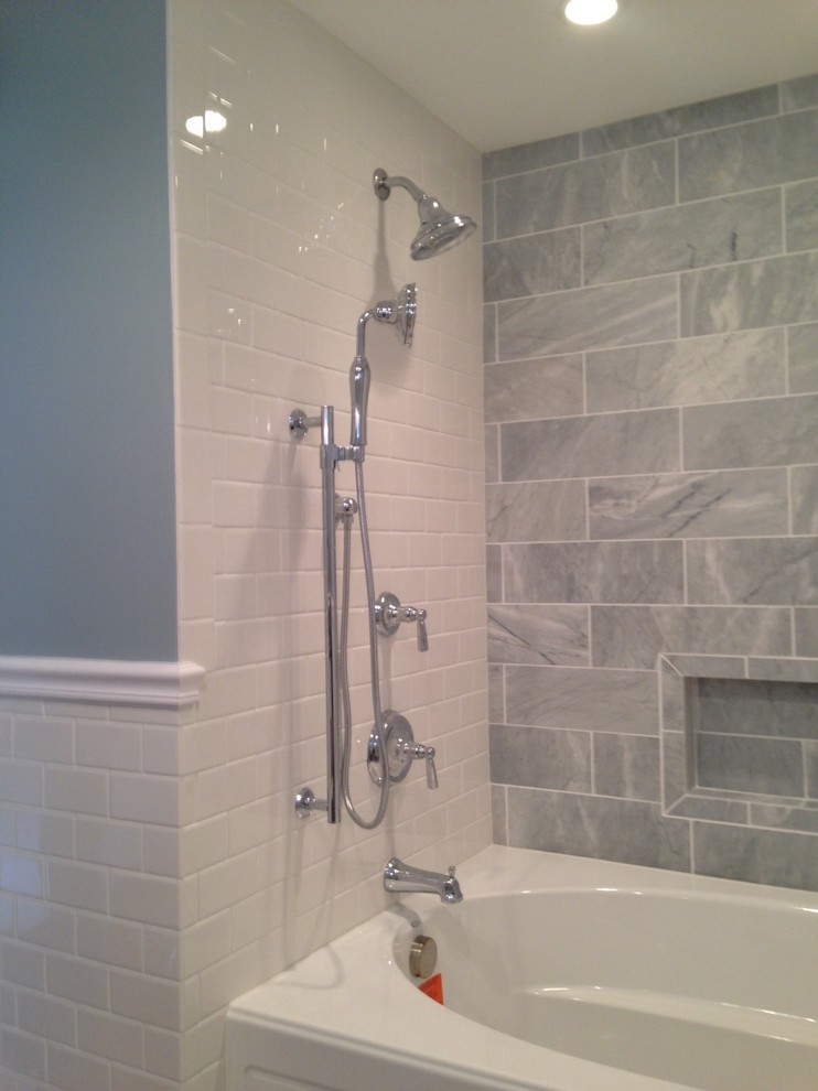 3/4 white tile and subway tile mosaic tile floor corner bathtub photo with shaker cabinets, white cabinets, blue walls and an undermount sink