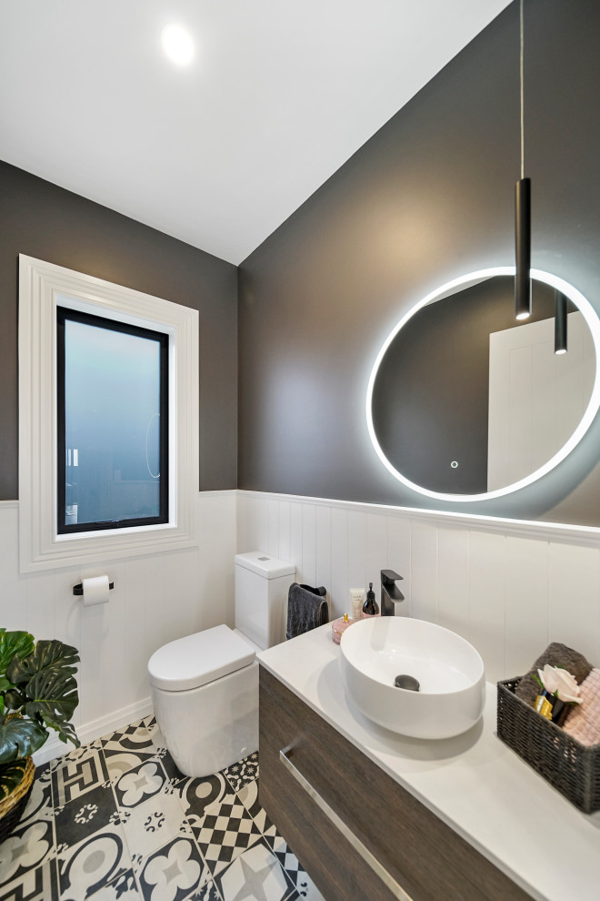 Mid-sized powder room in Auckland With Furniture-like Cabinets, Dark Wood Cabinets, a Wall-mount Toilet, White Tile, Grey Walls, Mosaic Tile Floors, a Vessel Sink, Quartzite Benchtops, Black Floor, White Benchtops, a Floating Vanity, Vaulted and Planked Wall Panelling.