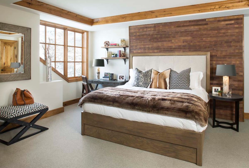 This is an example of an expansive country guest bedroom in Denver with white walls, carpet and no fireplace.