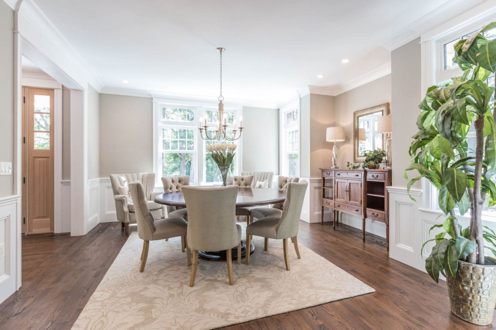 This is an example of a transitional separate dining room in Boston with beige walls, medium hardwood floors, no fireplace, brown floor, panelled walls and decorative wall panelling.