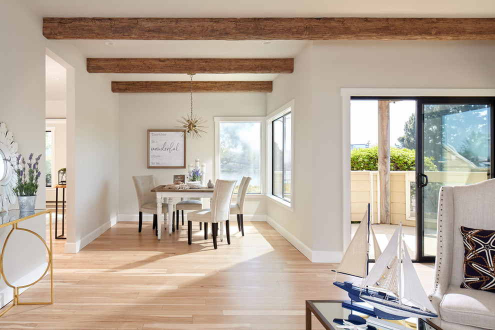 Photo of a mid-sized beach style open plan dining in San Francisco with grey walls, light hardwood floors, no fireplace and beige floor.