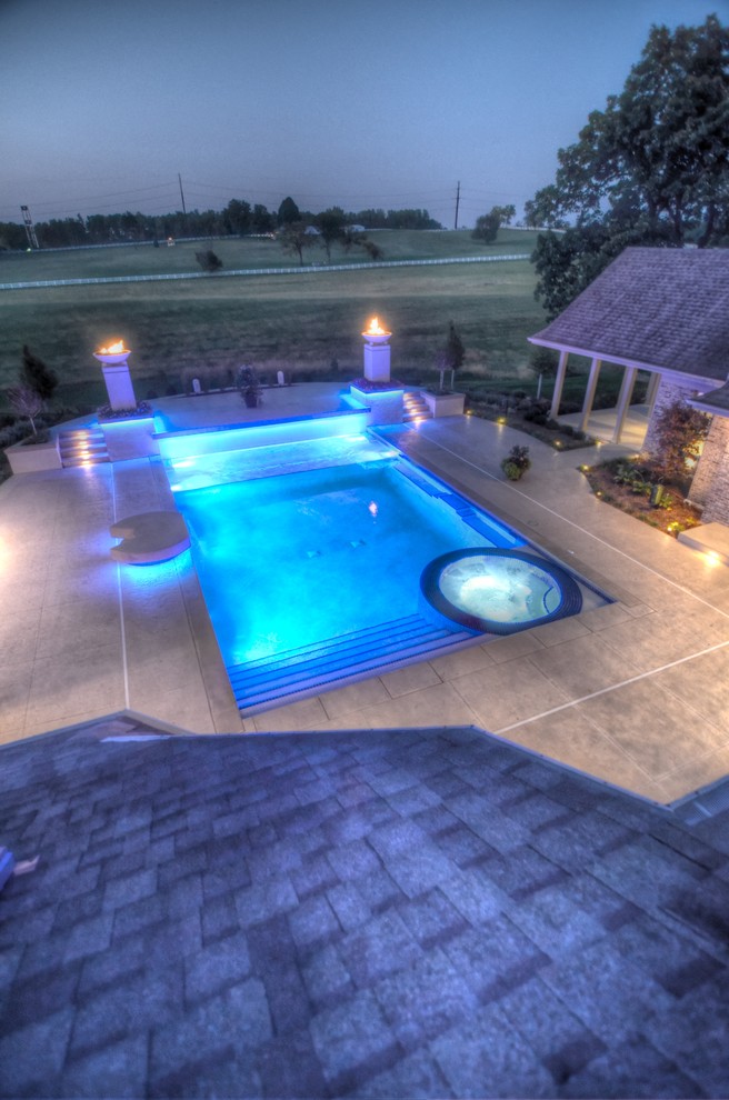 Example of a large transitional backyard concrete paver and rectangular natural hot tub design in Cedar Rapids
