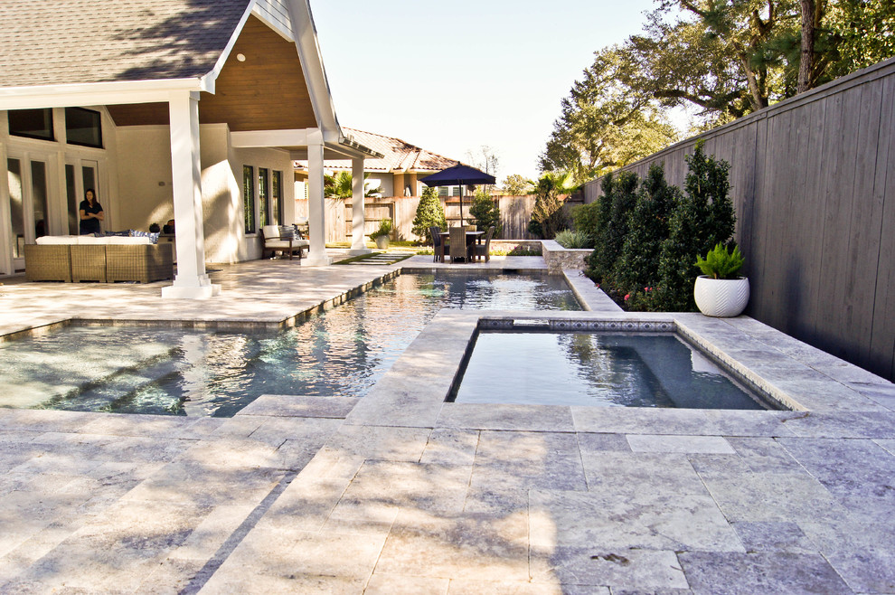 Photo of a small modern backyard custom-shaped lap pool in Houston with a hot tub and natural stone pavers.