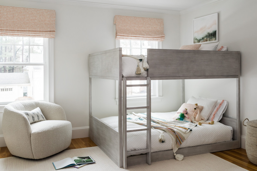 Design ideas for a transitional kids' bedroom for kids 4-10 years old and girls in Boston with white walls, medium hardwood floors and brown floor.
