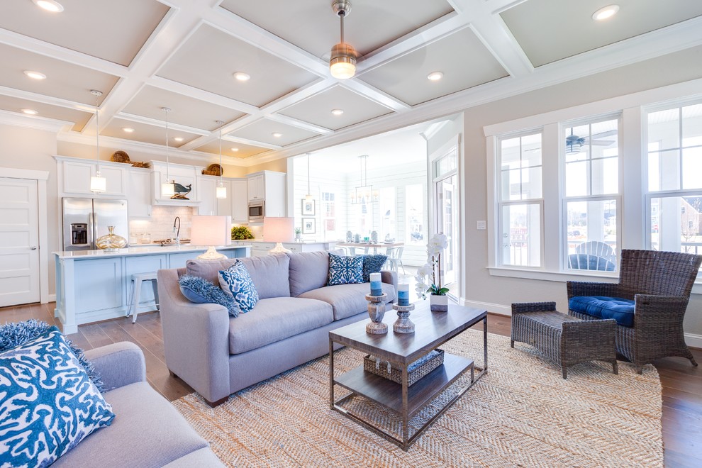 Inspiration for a large beach style open concept family room in Other with grey walls, medium hardwood floors, a standard fireplace, a tile fireplace surround and a built-in media wall.