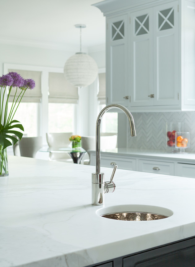 Inspiration for a transitional u-shaped black floor open concept kitchen remodel in New York with recessed-panel cabinets, white cabinets, marble countertops, mosaic tile backsplash and an island