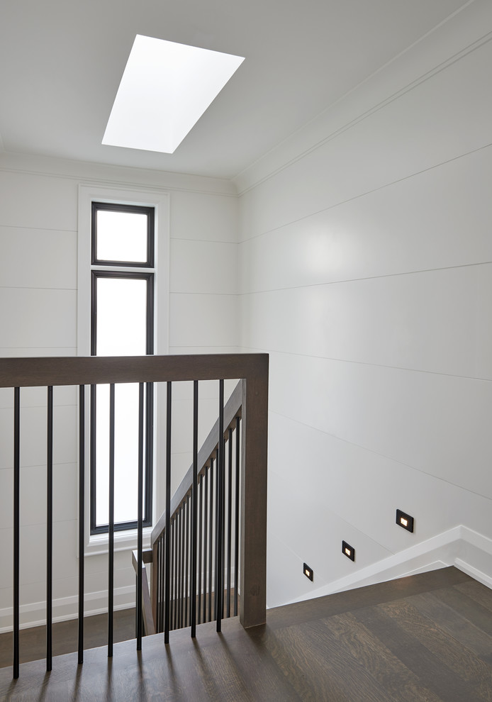 Photo of a mid-sized contemporary wood u-shaped staircase in Toronto with mixed railing.