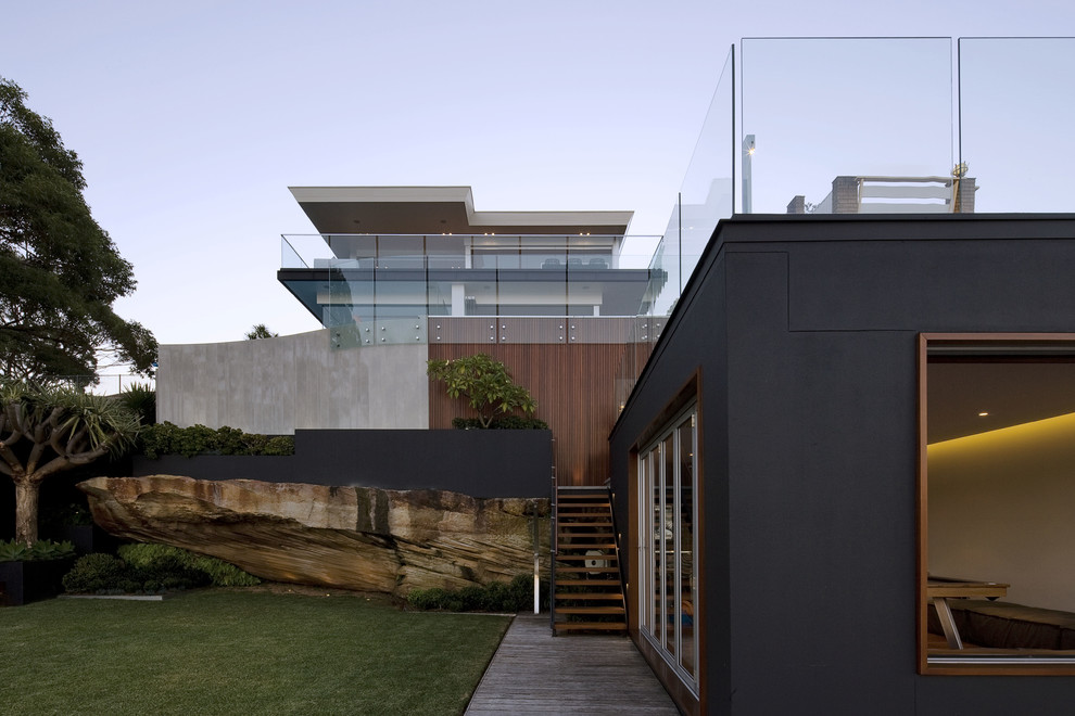 Design ideas for a contemporary two-storey black exterior in Sydney with mixed siding.