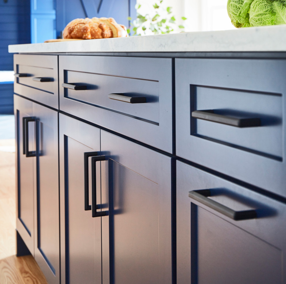 Inspiration for a large transitional galley medium tone wood floor and brown floor eat-in kitchen remodel in Chicago with an undermount sink, shaker cabinets, blue cabinets, quartzite countertops, white backsplash, porcelain backsplash, stainless steel appliances, an island and white countertops