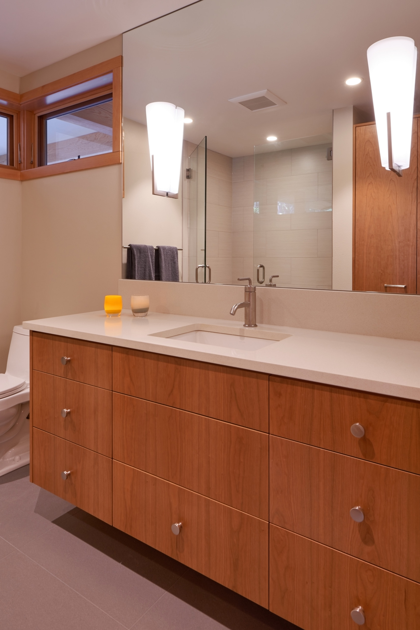 Master bathroom with vertical grain cherry vanity and quartz countertop.