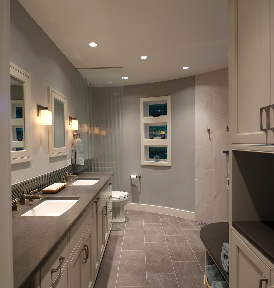 Inspiration for a mid-sized transitional master bathroom in Seattle with an undermount sink, beaded inset cabinets, white cabinets, engineered quartz benchtops, a curbless shower, a two-piece toilet, gray tile, porcelain tile, blue walls and porcelain floors.