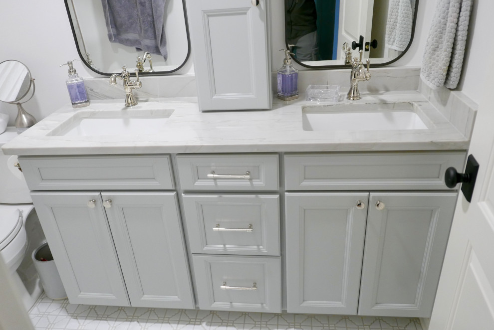 Photo of a mid-sized transitional kids bathroom in Other with recessed-panel cabinets, grey cabinets, an alcove tub, a shower/bathtub combo, a two-piece toilet, white tile, porcelain tile, white walls, mosaic tile floors, an undermount sink, quartzite benchtops, white floor, a shower curtain, grey benchtops, a niche, a double vanity and a built-in vanity.