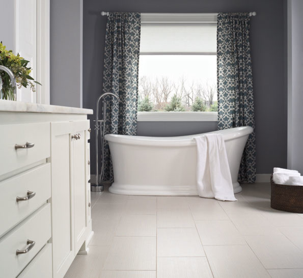 Inspiration for a mid-sized contemporary master bathroom in Orlando with flat-panel cabinets, dark wood cabinets, a freestanding tub, a one-piece toilet, beige tile, brown tile, ceramic tile, white walls, linoleum floors, a drop-in sink and wood benchtops.