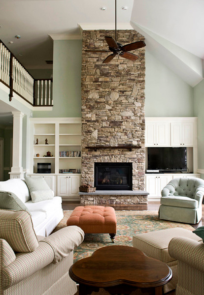 Design ideas for a country open concept living room in Raleigh with blue walls, a standard fireplace and a stone fireplace surround.