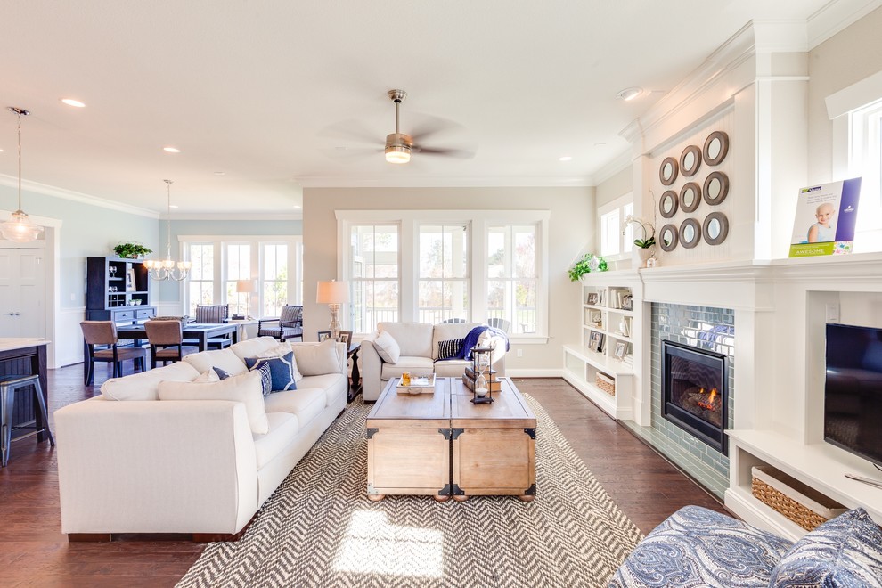 Large beach style open concept family room in Other with beige walls, dark hardwood floors, a standard fireplace, a tile fireplace surround and a built-in media wall.