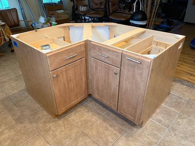 Eat-in kitchen - mid-sized eat-in kitchen idea with louvered cabinets, brown cabinets and an island