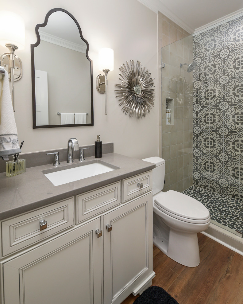 Design ideas for a small transitional 3/4 bathroom in Other with grey cabinets, an alcove shower, a two-piece toilet, beige tile, black and white tile, beige walls, medium hardwood floors, an undermount sink, brown floor, a hinged shower door, grey benchtops and recessed-panel cabinets.