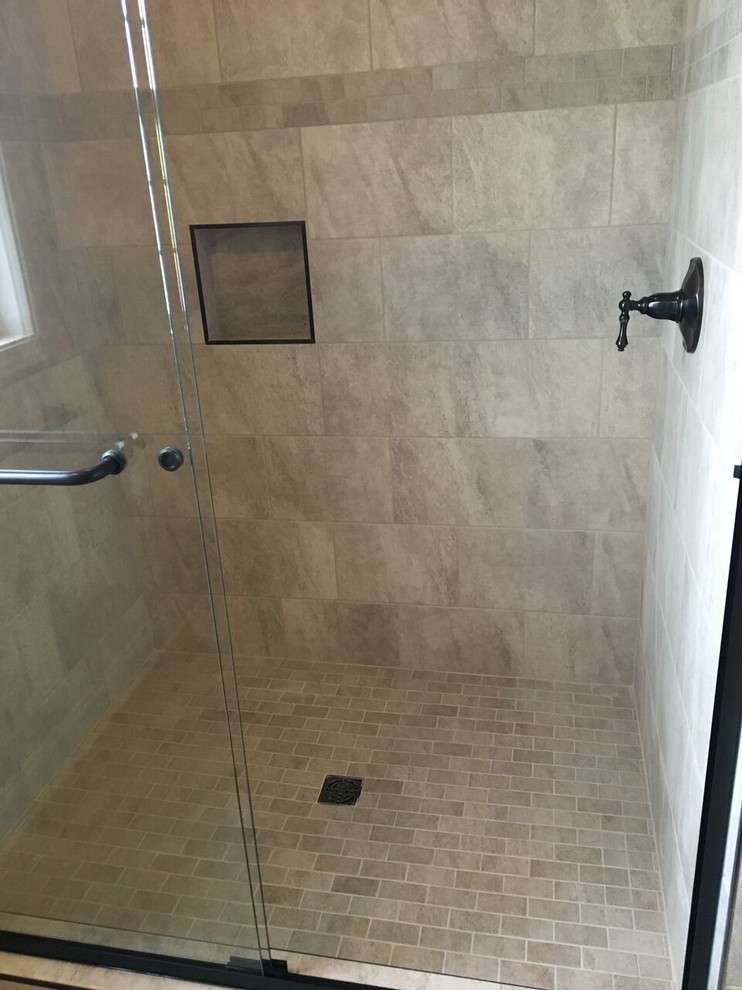 Photo of a mid-sized arts and crafts bathroom in Other with an alcove shower, brown tile, ceramic tile, ceramic floors, brown floor and a sliding shower screen.