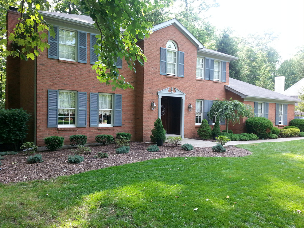Photo of a mid-sized transitional two-storey brick red exterior in Cincinnati.