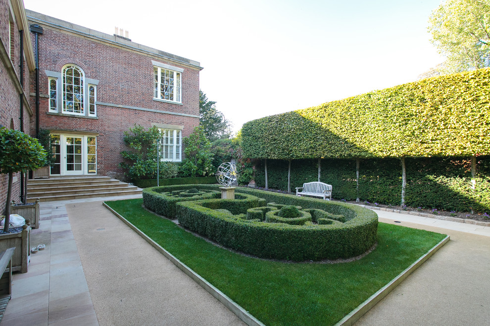 This is an example of a traditional partial sun courtyard gravel formal garden.