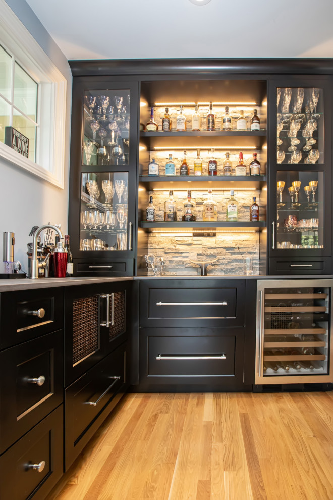 Large modern home bar in Boston with medium hardwood floors and brown floor.