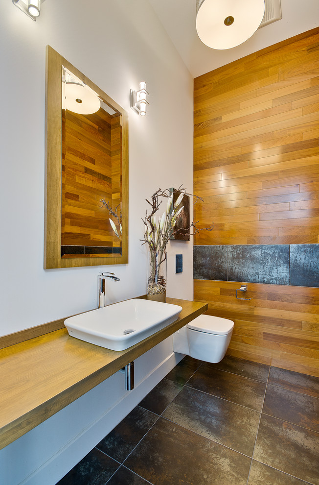 Inspiration for a contemporary powder room in Montreal with a vessel sink and a wall-mount toilet.
