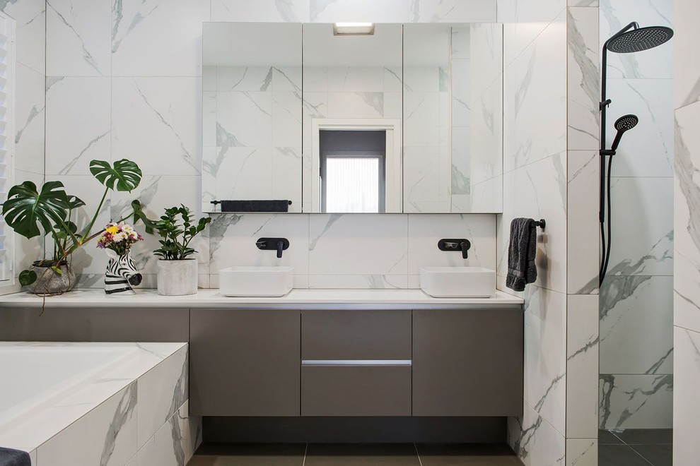 Mid-sized modern master bathroom in Adelaide with black and white tile, furniture-like cabinets, grey cabinets, an open shower, porcelain floors, grey floor, an open shower, white benchtops, a double vanity and a floating vanity.