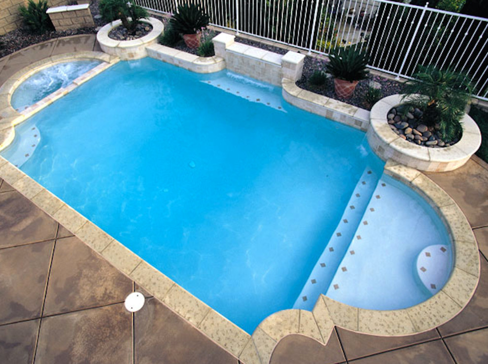 This is an example of a mid-sized contemporary backyard lap pool in Austin with a hot tub.