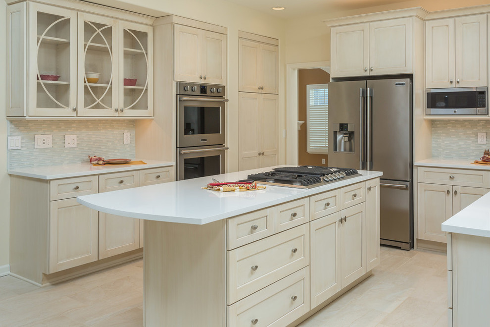 Inspiration for a mid-sized transitional l-shaped eat-in kitchen remodel with recessed-panel cabinets, beige cabinets, gray backsplash, stainless steel appliances and an island