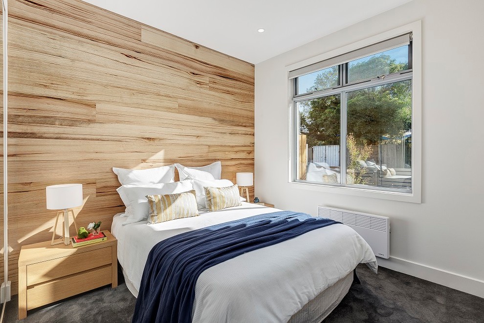 Transitional bedroom in Melbourne with white walls, carpet and grey floor.