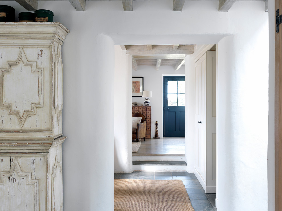 Mid-sized country hallway in London with white walls, slate floors and grey floor.