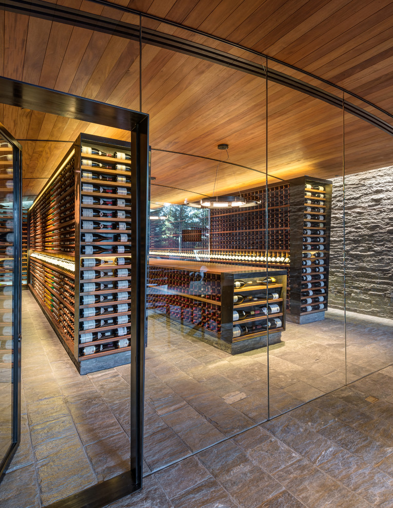 This is an example of an expansive country wine cellar in Other with display racks.