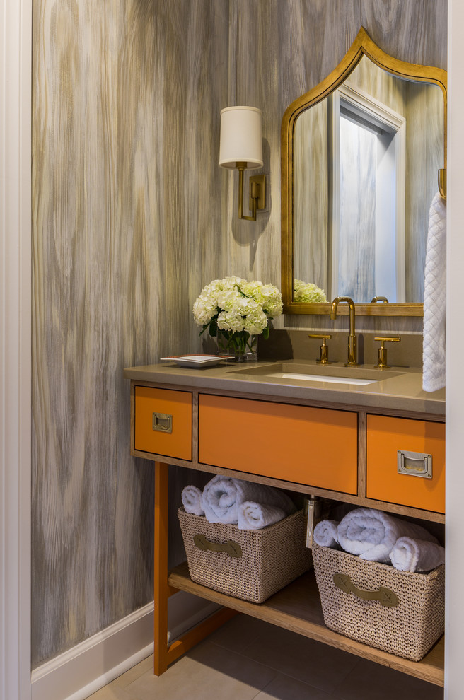 Inspiration for a mid-sized transitional powder room in Little Rock with an undermount sink, orange cabinets, beige tile, marble floors and brown benchtops.
