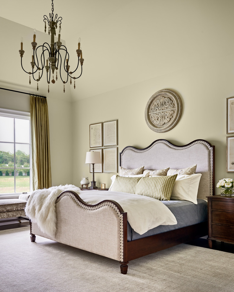 Inspiration for a traditional master bedroom in Charlotte with beige walls.