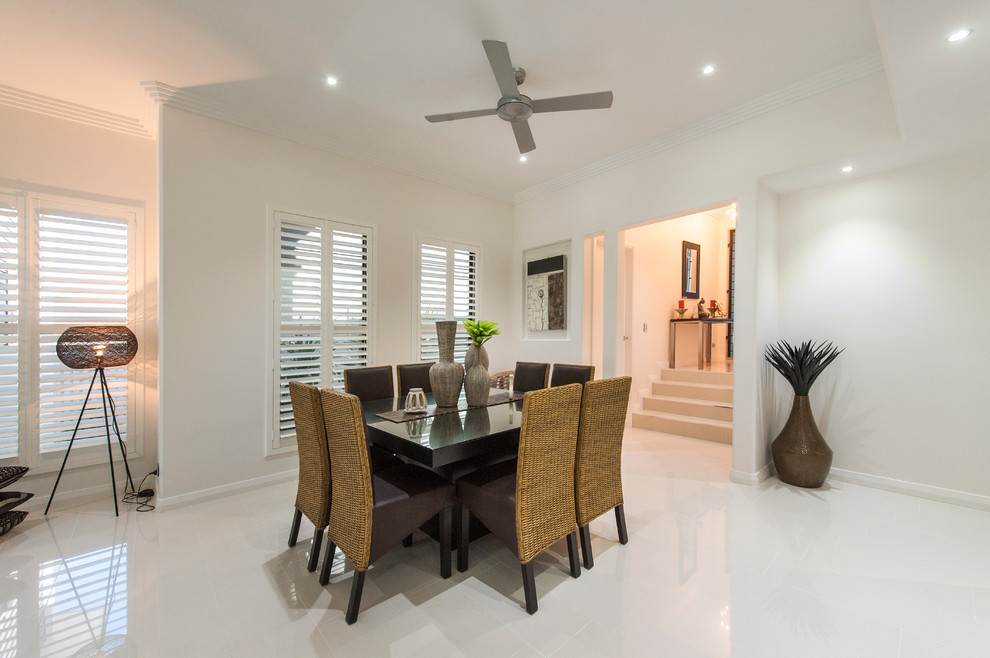 This is an example of a large modern kitchen/dining combo in Brisbane with white walls and ceramic floors.